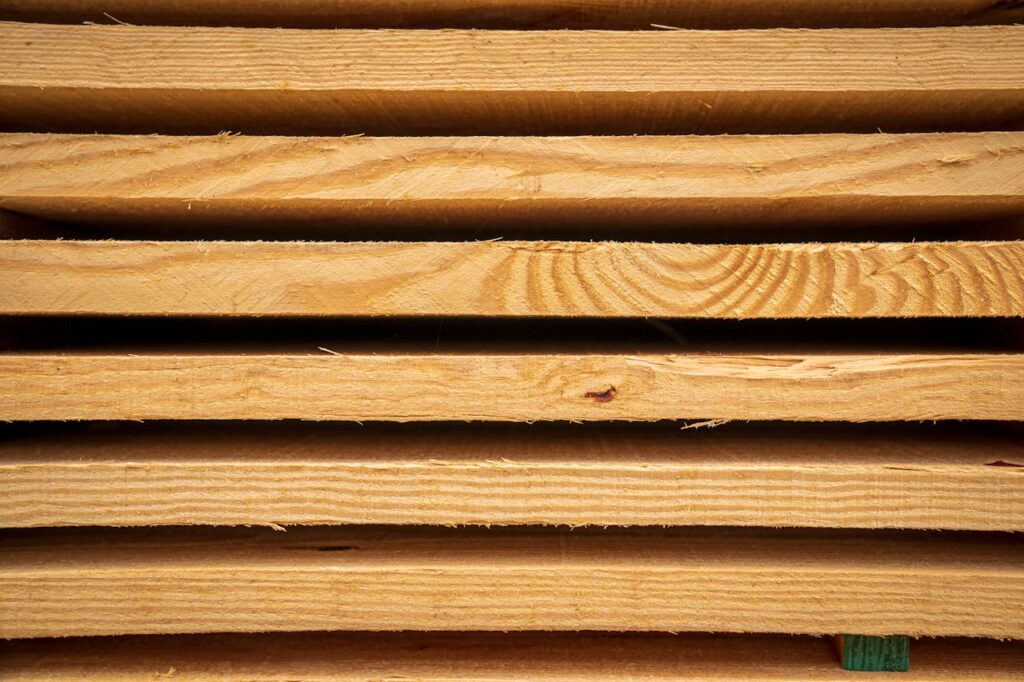 Close-up view of stacked hardwood planks ready for carpentry or construction use.